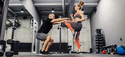 A woman working out with her personal trainer